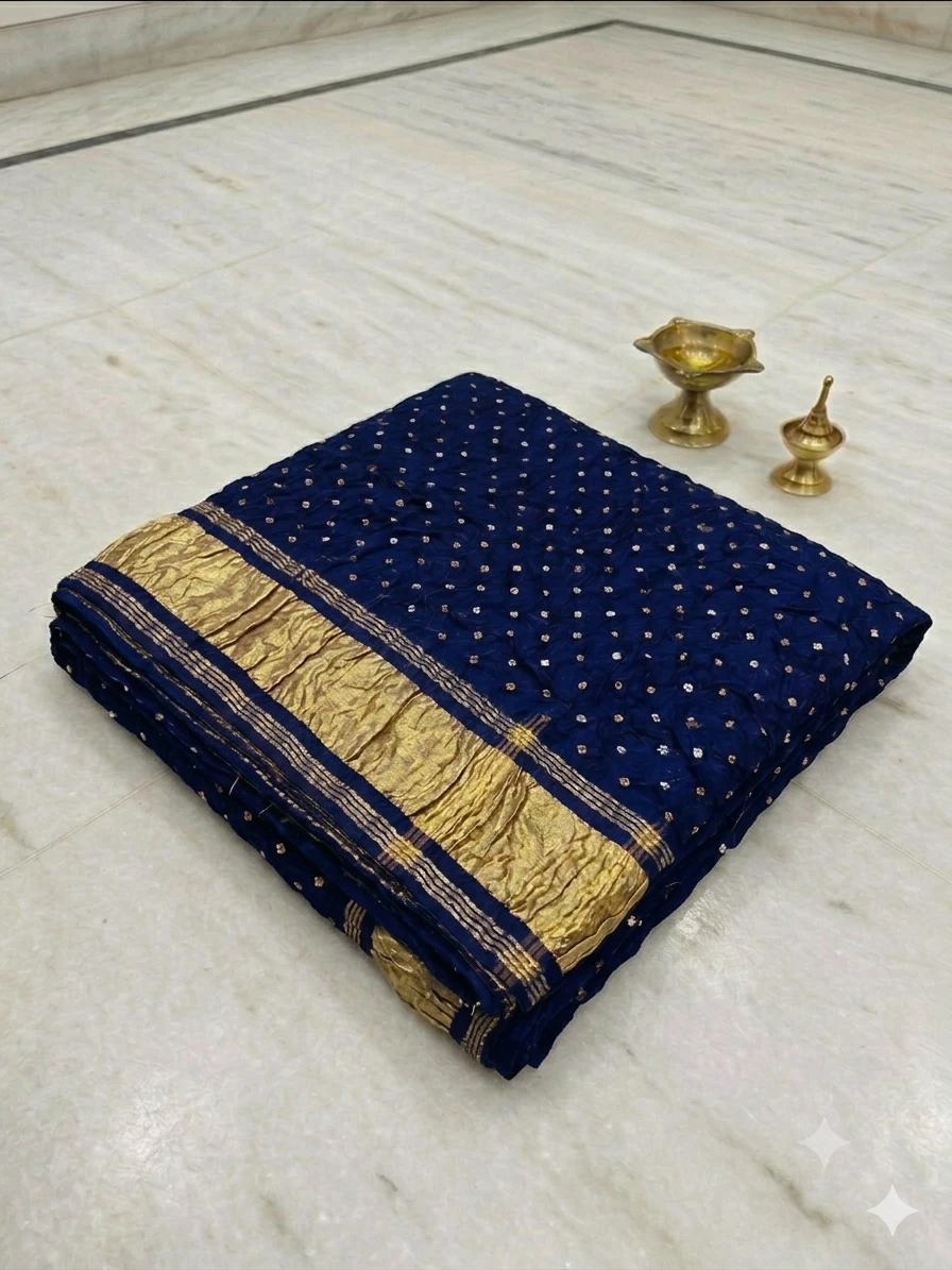 Navy blue crinkled dupatta with gold dotted embellishments and broad gold border draped on a hanger