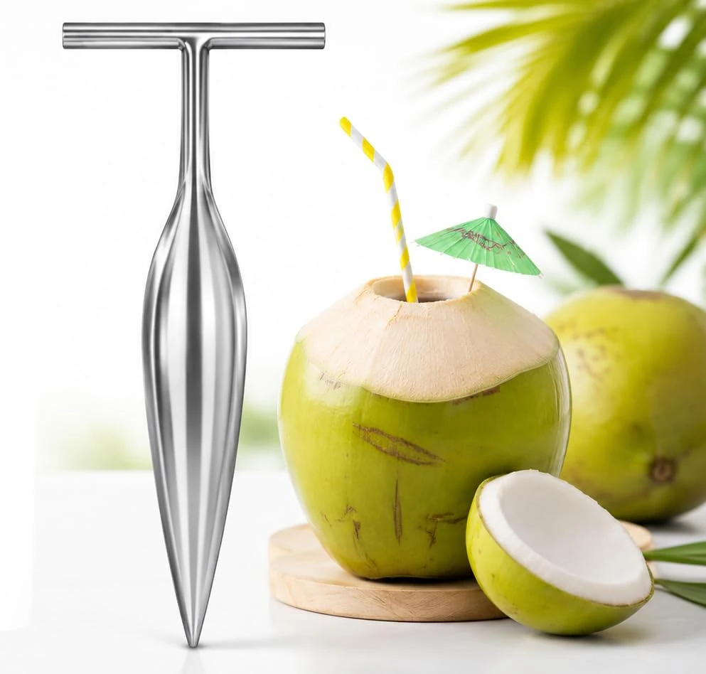 Stainless steel T-handle coconut opener beside a green tender coconut with straw and splash