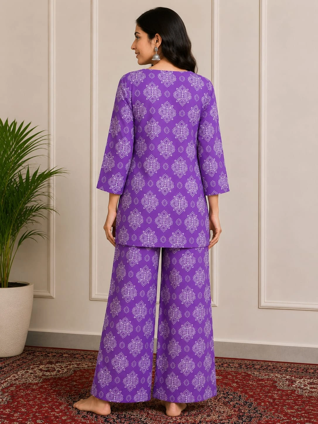Woman wearing a purple printed kurta with three-quarter sleeves and matching wide-leg palazzo pants