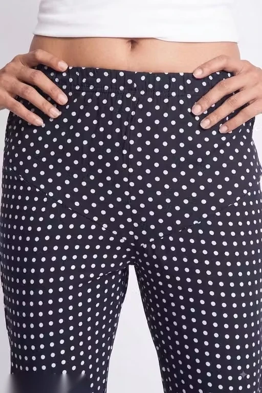 Close-up of the waistband and upper legs, highlighting the navy fabric and small white dot pattern