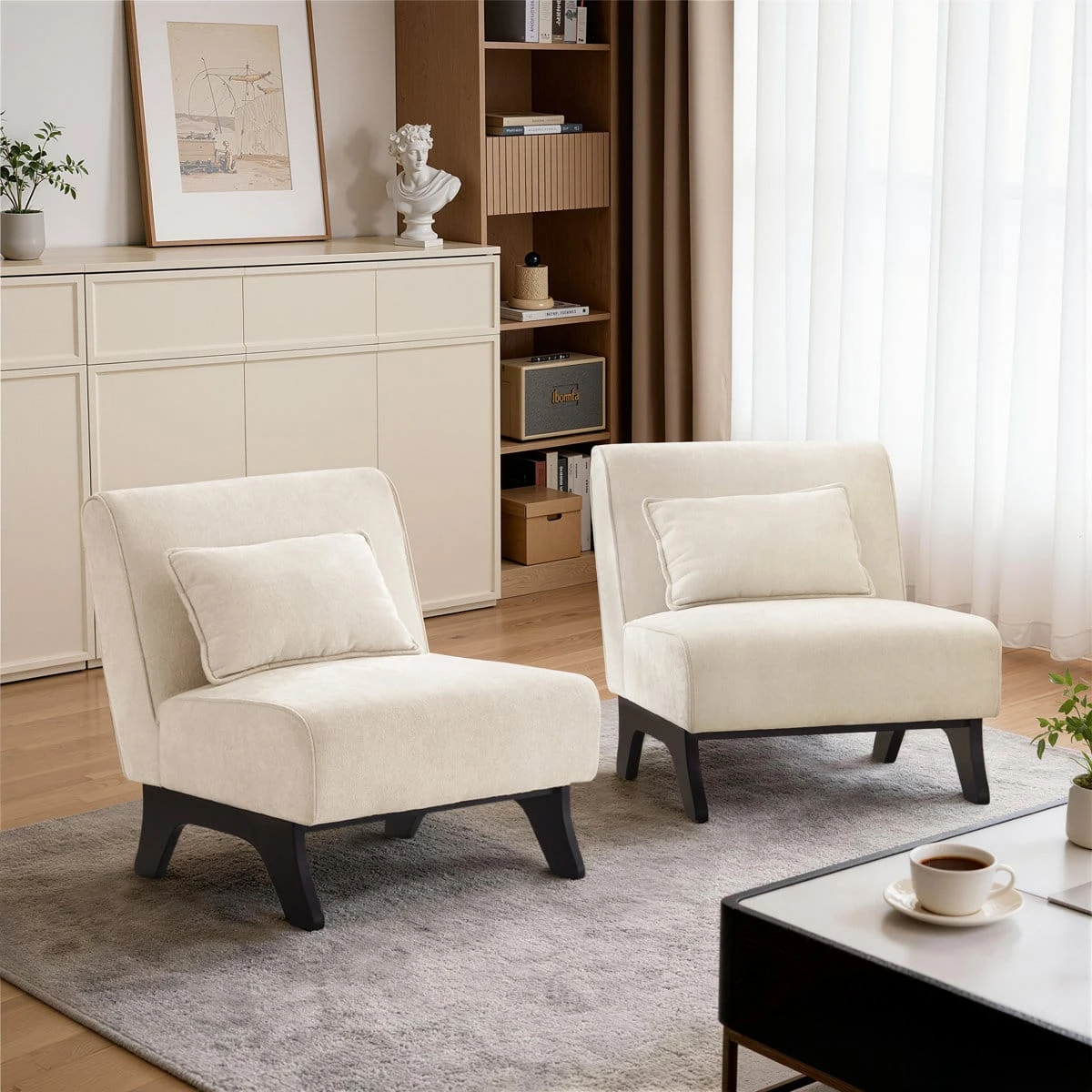 Two cream accent chairs styled in a living room, showing the chair as a matching set