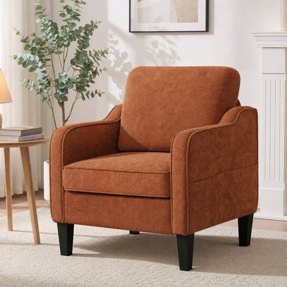 Rust brown armchair shown in a bright room beside a side table and tall plant