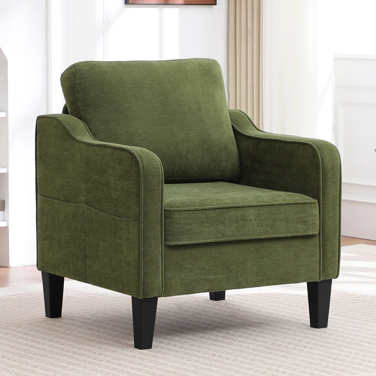 Front-left view of green fabric armchair highlighting dual side storage pockets and cushioned seat