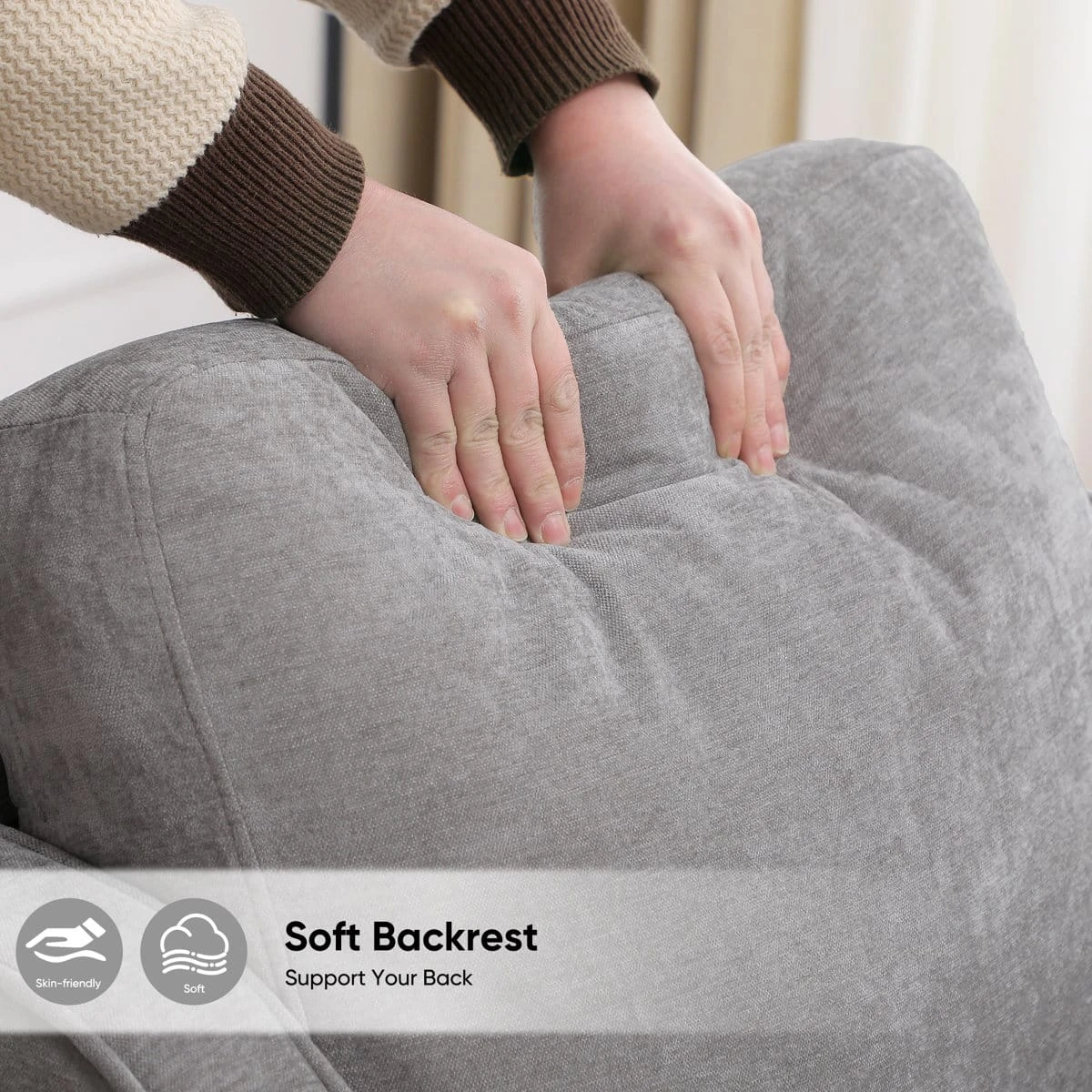 Close-up of hands pressing the cushioned grey backrest with soft backrest text overlay