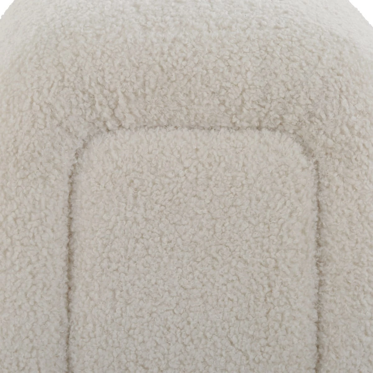 Close-up of the sofa arm showing textured ivory boucle fabric and stitched panel detailing