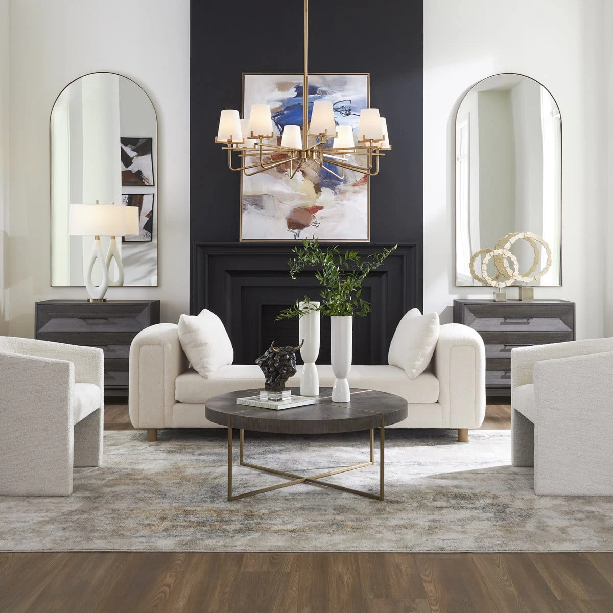 Ivory boucle sofa styled in a living room with matching pillows, dark fireplace, and round coffee table