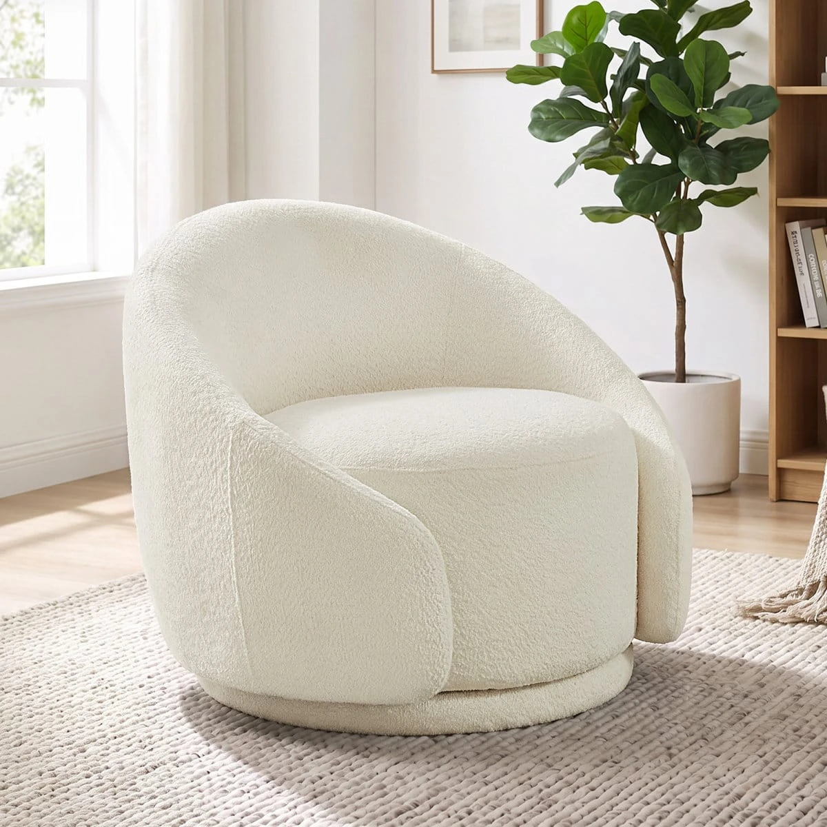 Cream swivel accent chair styled in a bright room beside a potted plant and bookcase
