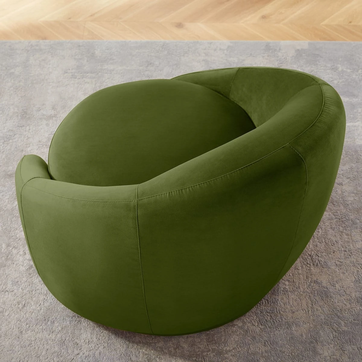 Rear angled view highlighting the curved wraparound back and smooth velvet upholstery