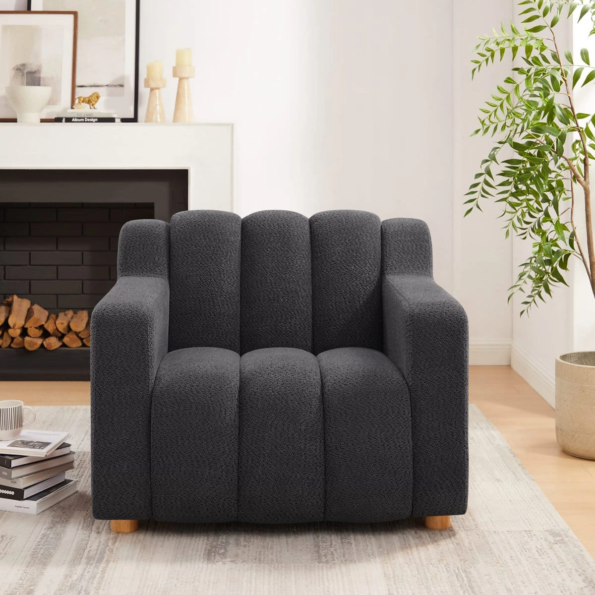 Straight-on room view of the charcoal boucle armchair with sculpted backrest and blocky arms