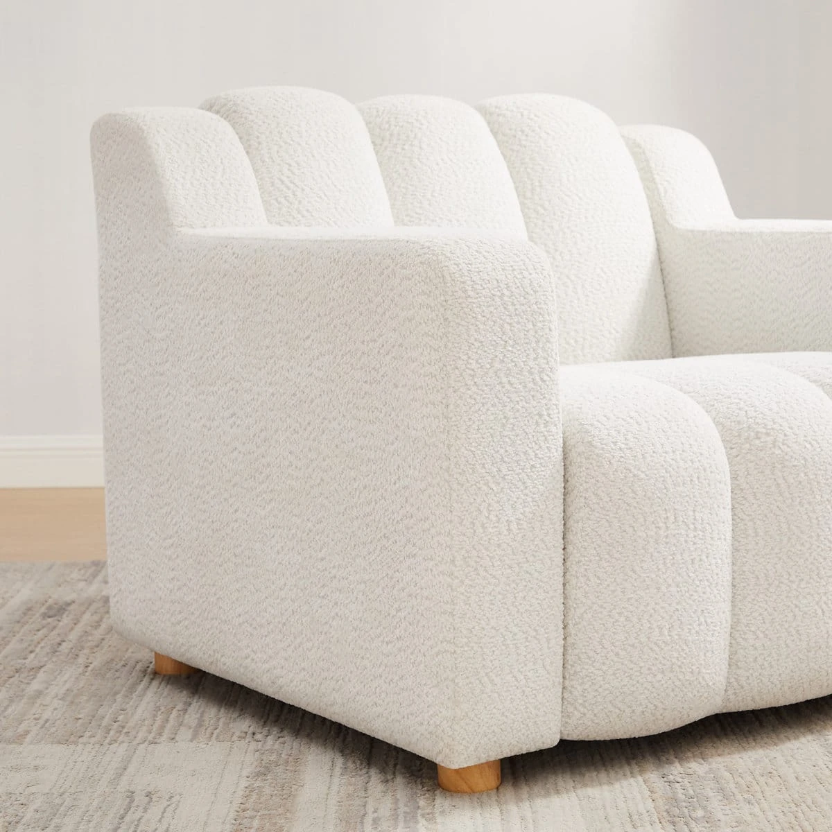 White 40 inch boucle fabric upholstered accent chair with channel back and wooden legs