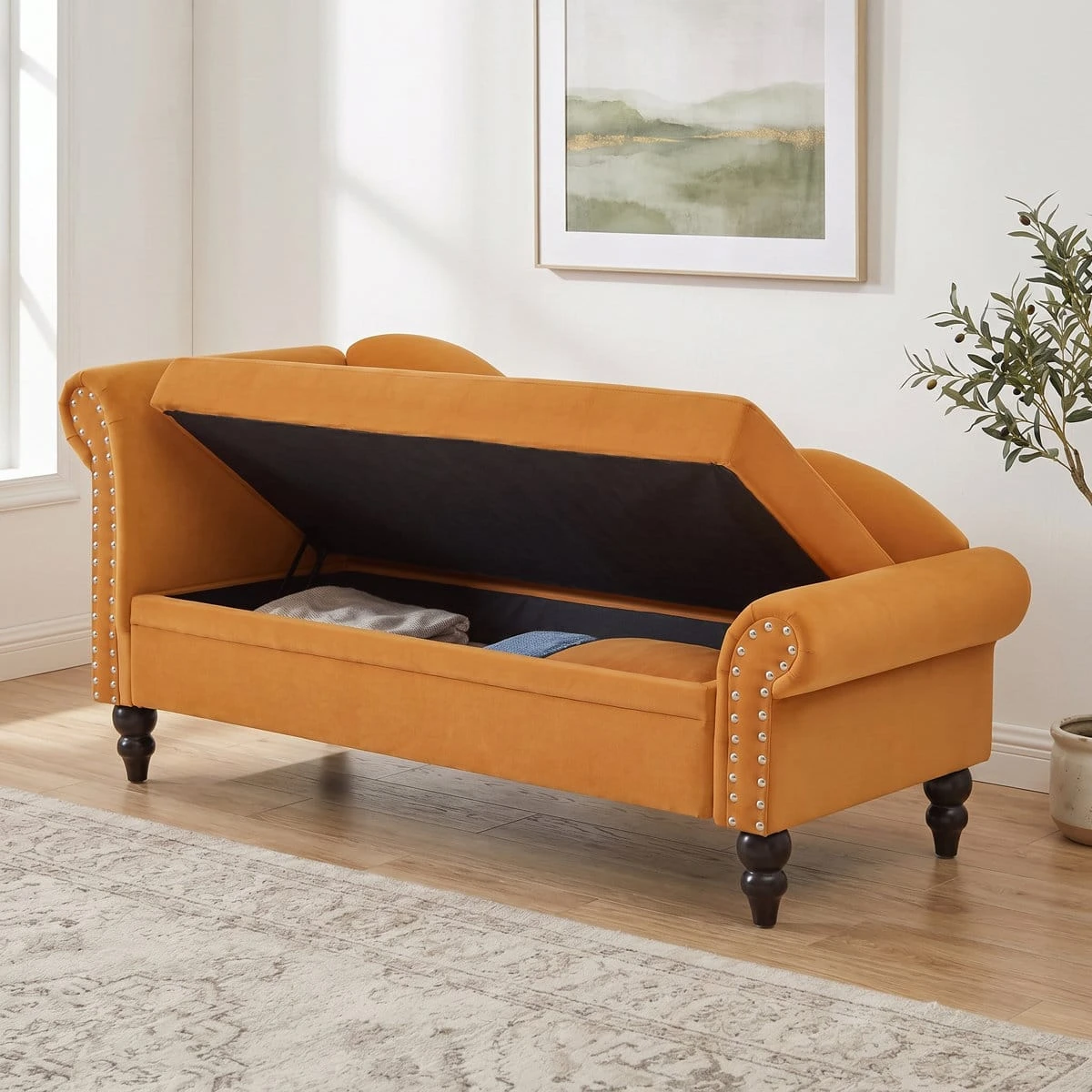 Lift-top seat opened to show hidden storage compartment inside the velvet chaise bench