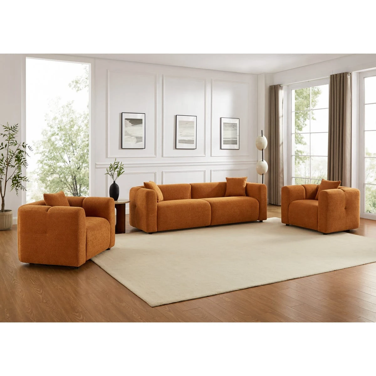 Wider room view showing the rust orange sofa from a slight side angle with rounded arms and textured upholstery