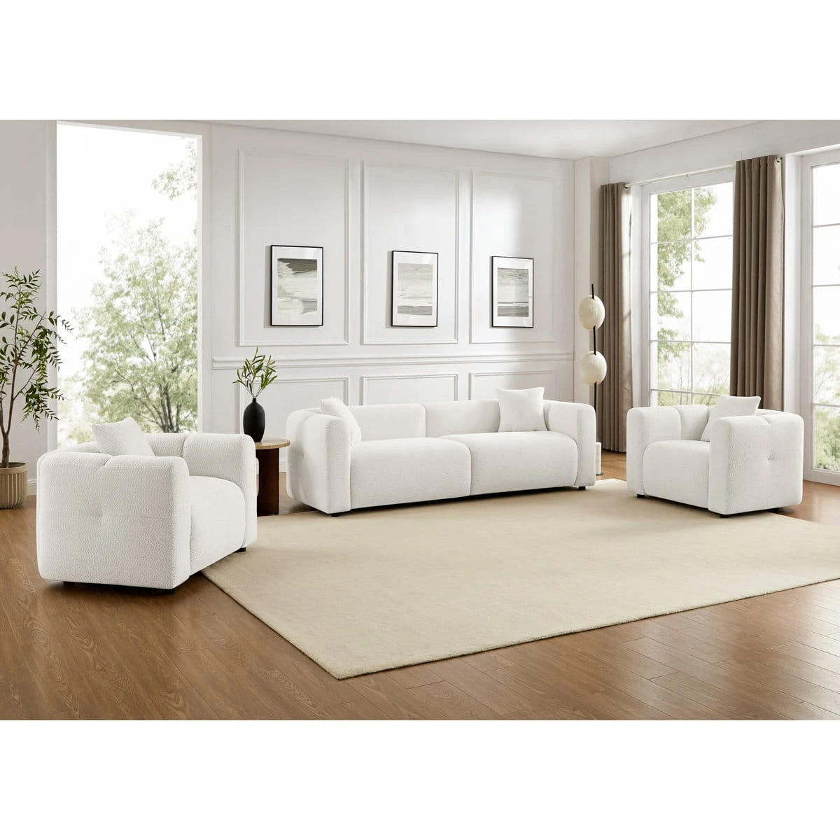 Wider room view showing the textured white sofa set with rounded arms and matching accent pillows