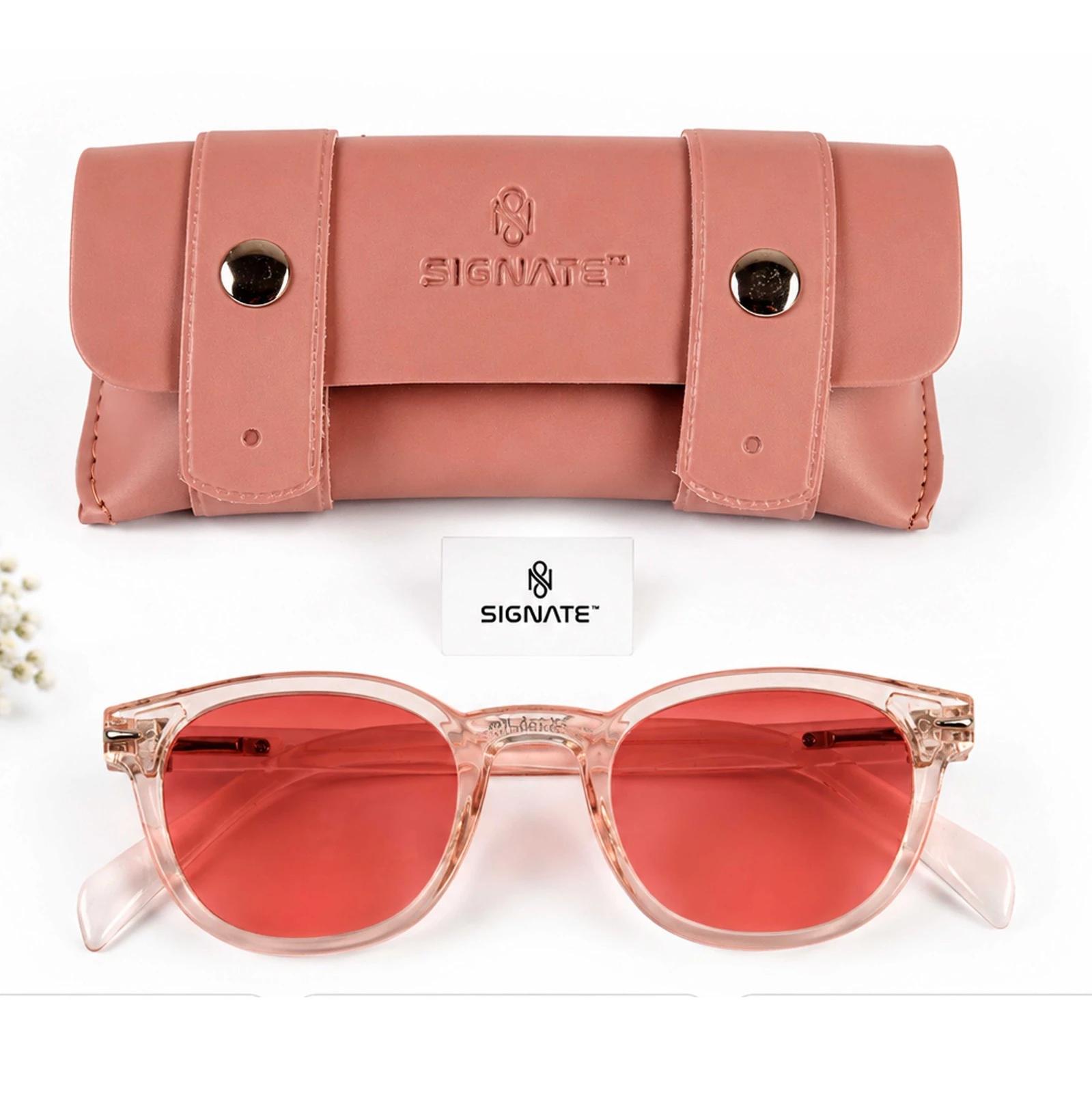 Signate sunglasses displayed below a pink snap-button carrying case and brand card