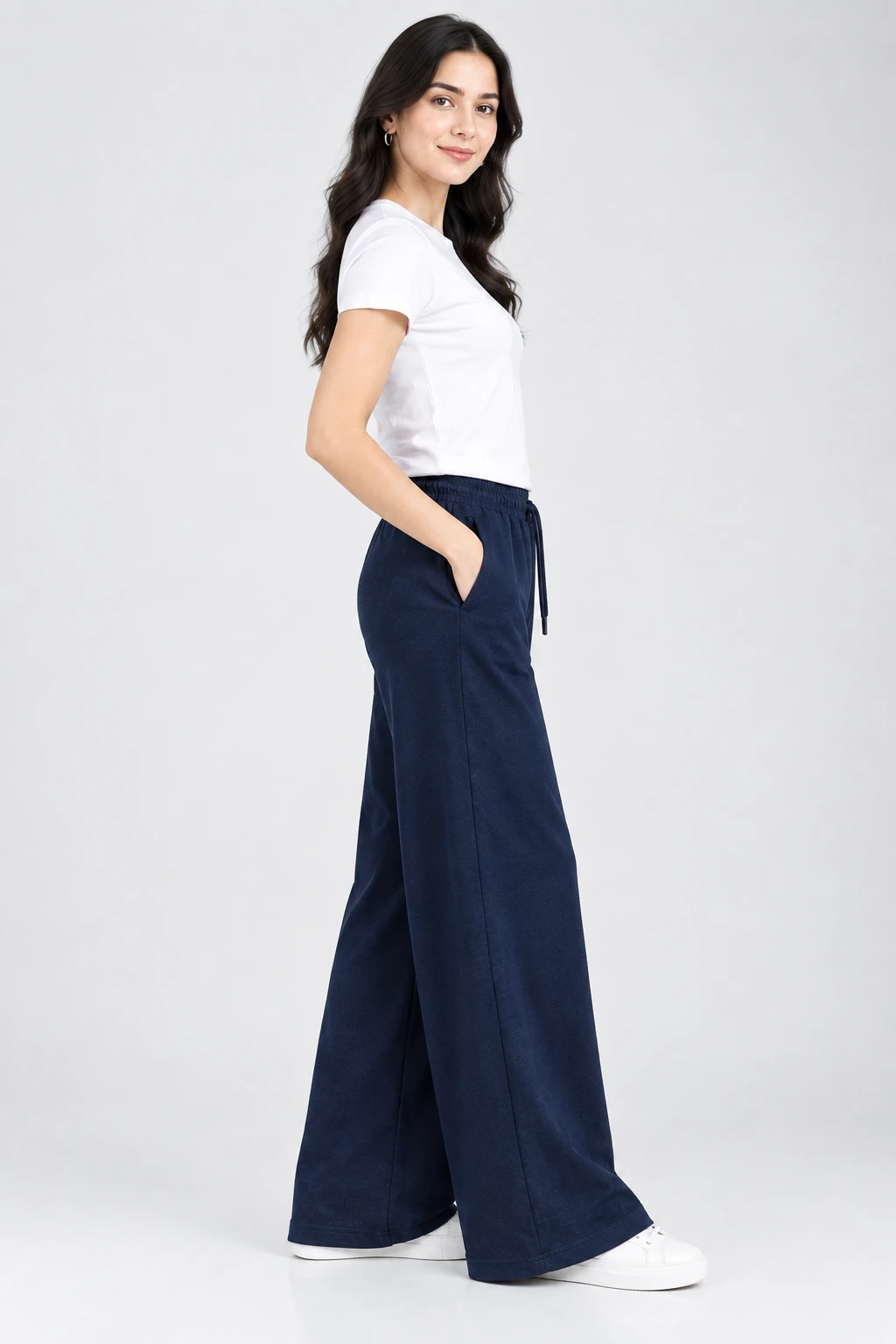 Side profile of navy wide-leg lounge pants with elastic drawstring waist and hand in pocket