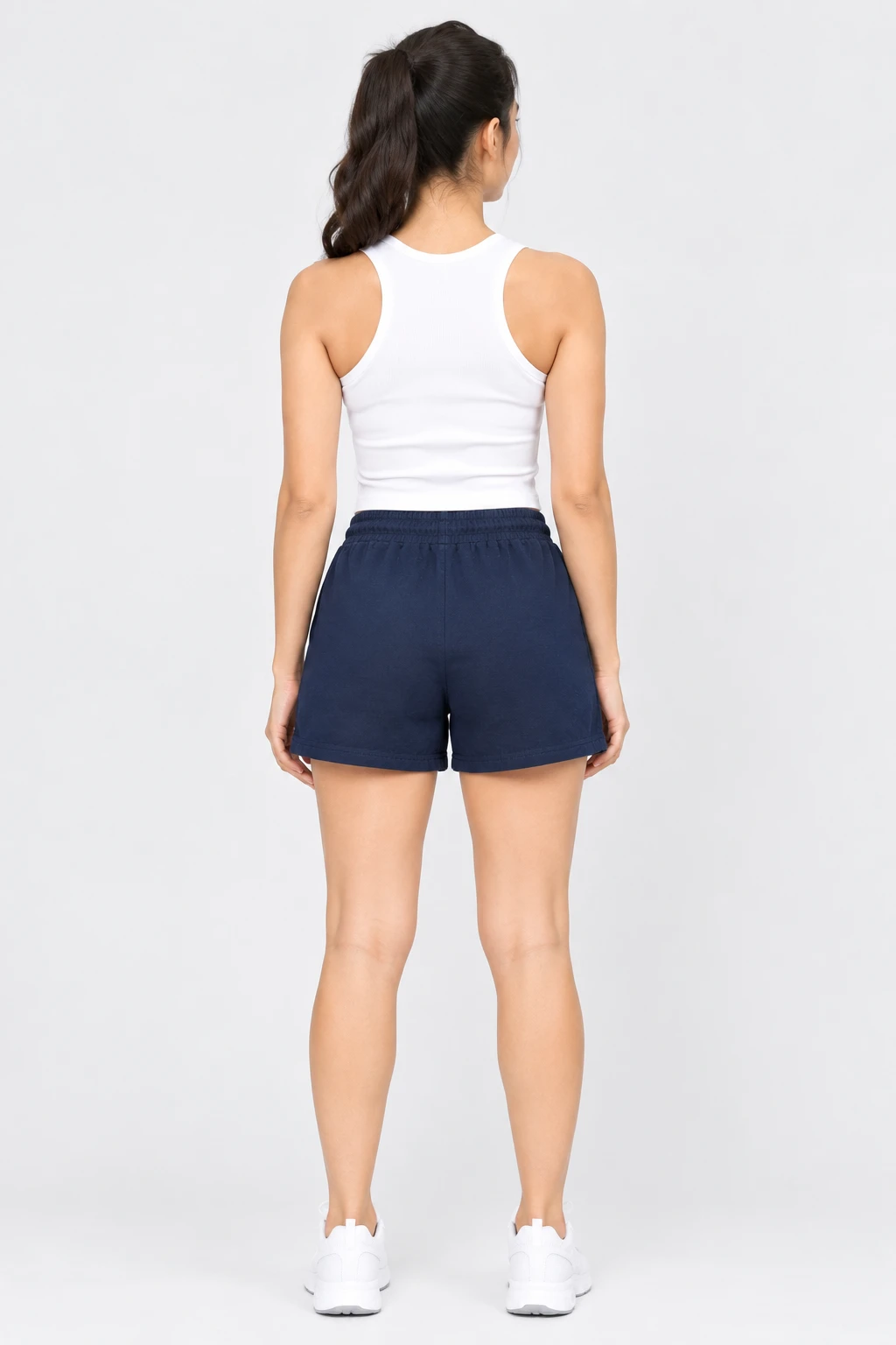 Back view of navy blue shorts on a model, highlighting the elastic waist and clean pocket-free rear