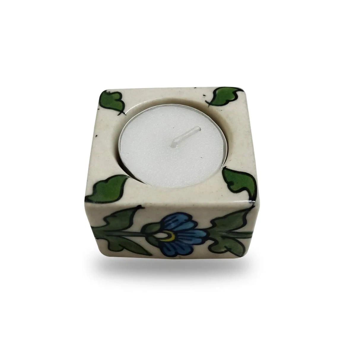 Single square tea light holder with white candle, blue flower motif and green corner leaves