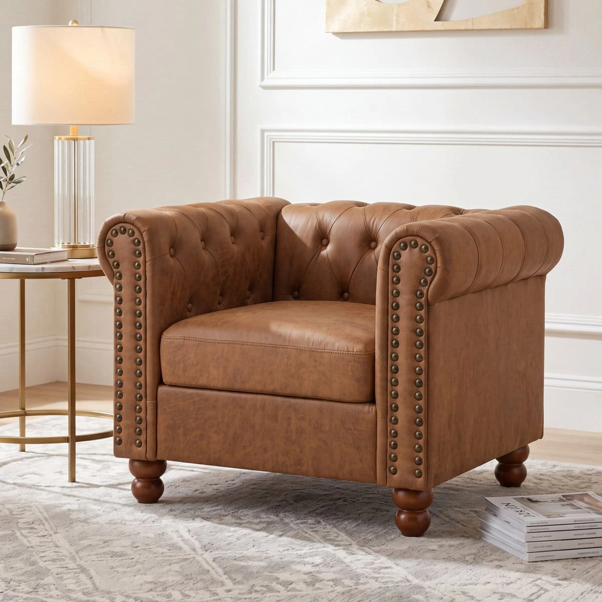 Single tan brown Chesterfield armchair angled left, with button tufting, rolled arms and nailhead trim
