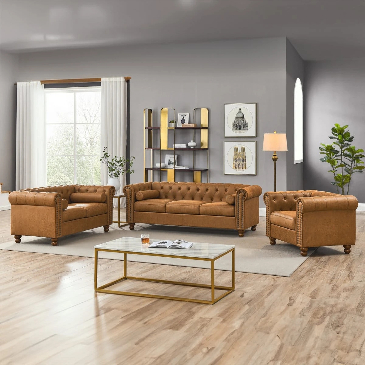 Three-piece Chesterfield set with tan brown sofa and two armchairs arranged around a coffee table