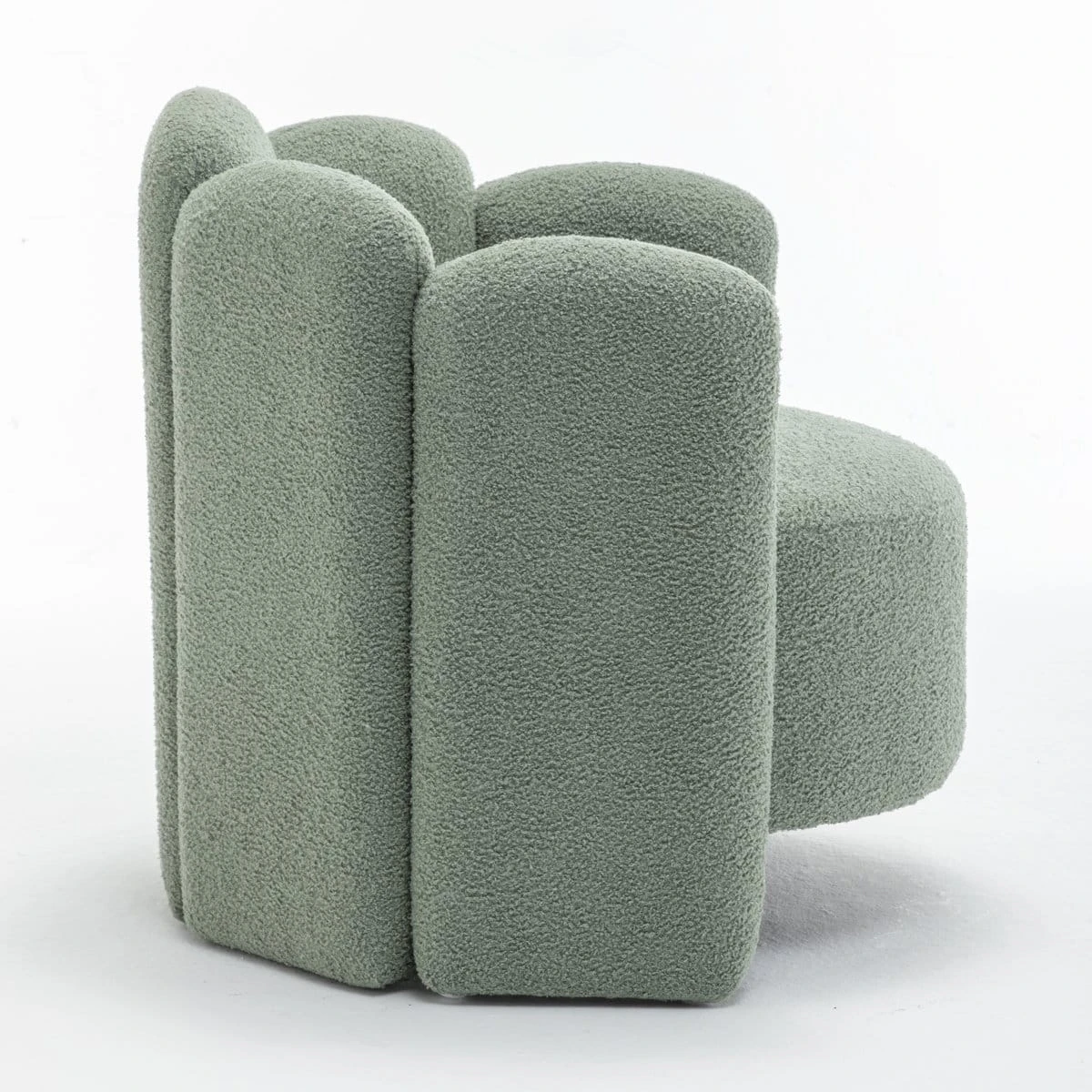 Side angle of the boucle armchair showing curved backrest and rounded arm panel