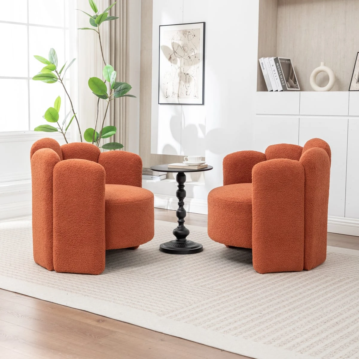 Angled room view of matching rust textured accent chairs on a light rug near a window and shelving