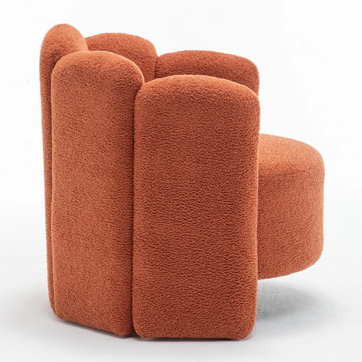 Side profile of the rust boucle chair showing rounded arms, curved back and deep cushioned seat