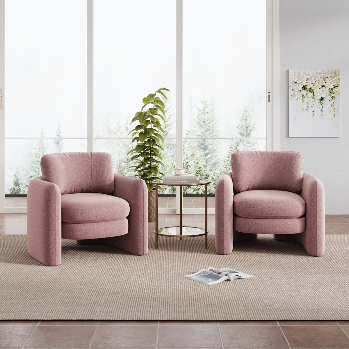 Two matching blush pink armchairs styled with a round side table in a sunlit room