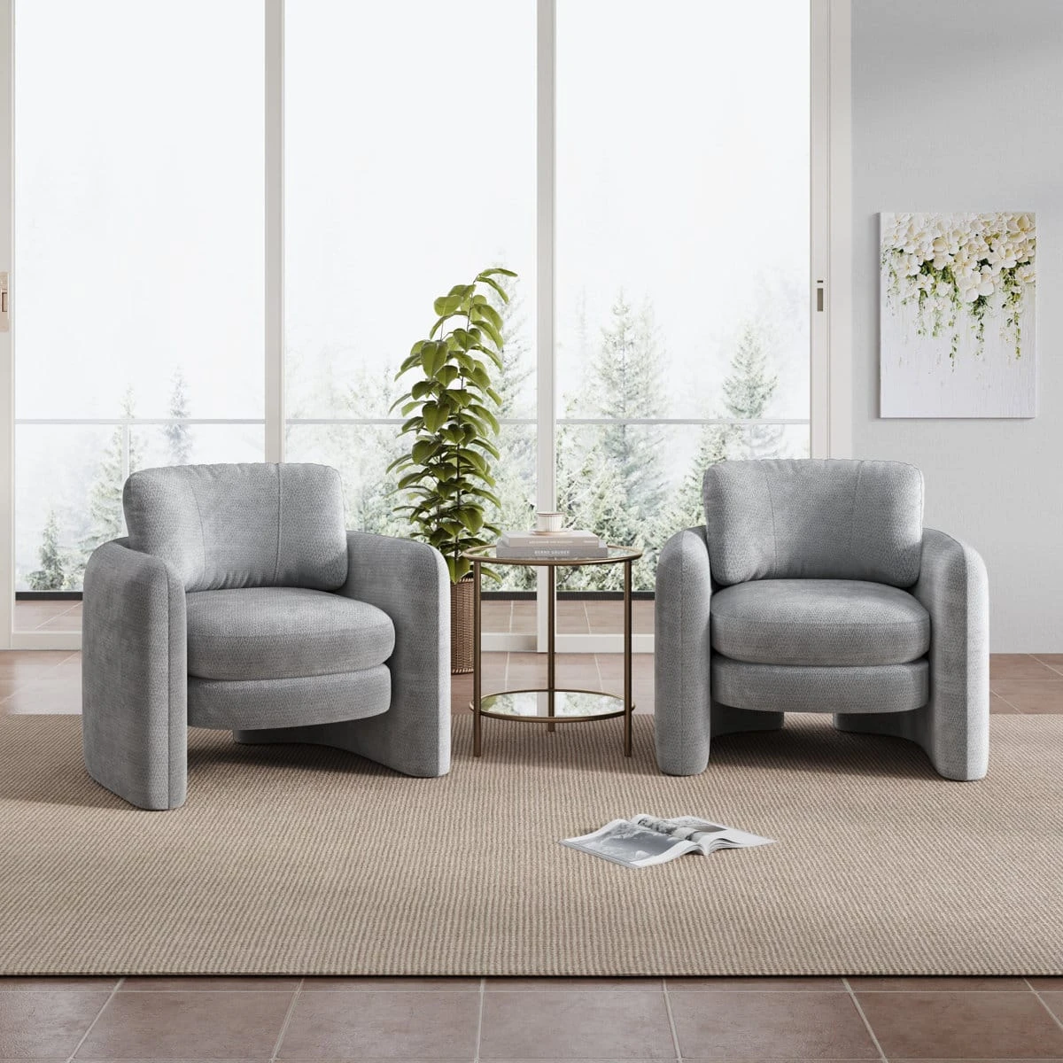 Two matching grey accent chairs displayed with a round side table in a bright room