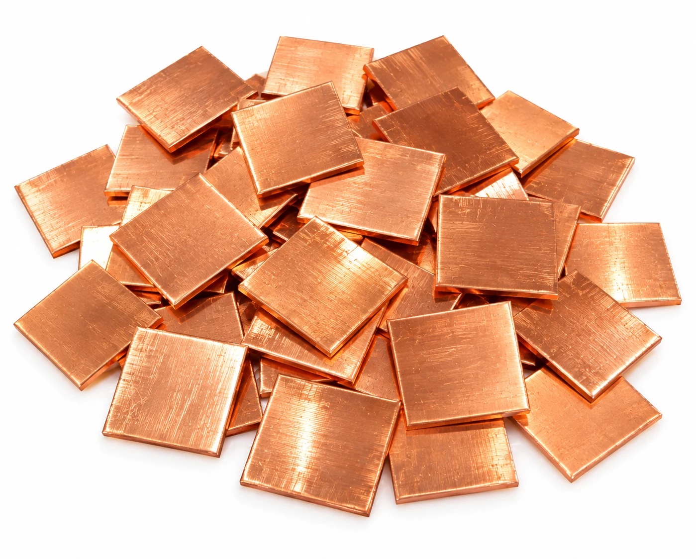 Pile of  copper square pieces  overlapping on a white background, showing multiple pieces and reflective surfaces