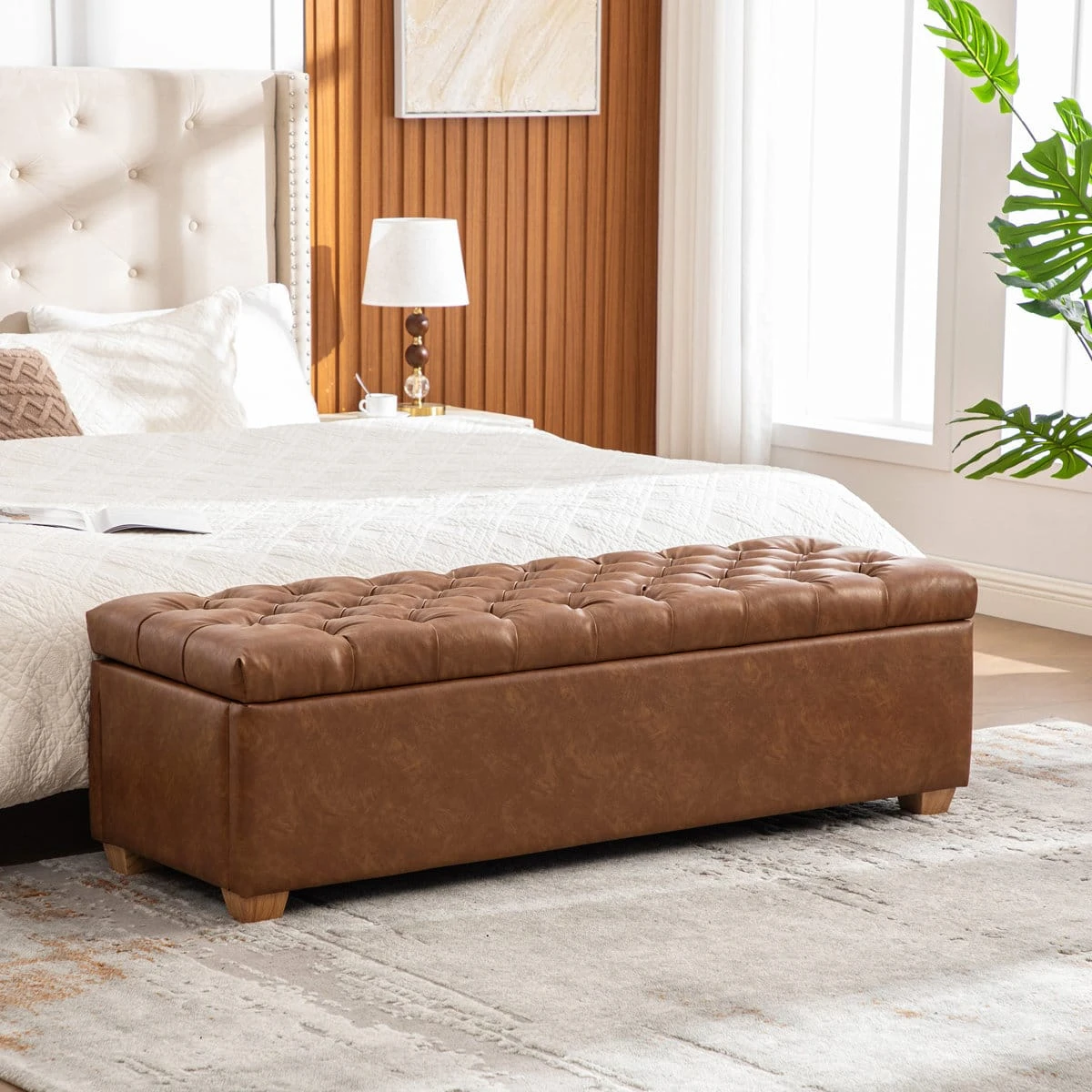 Closed rectangular ottoman bench styled in a bedroom at the end of a bed