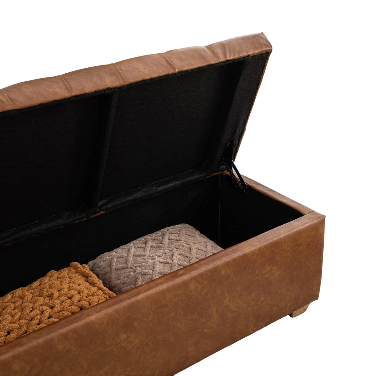 Open storage compartment detail showing the black-lined interior and lift support hinge