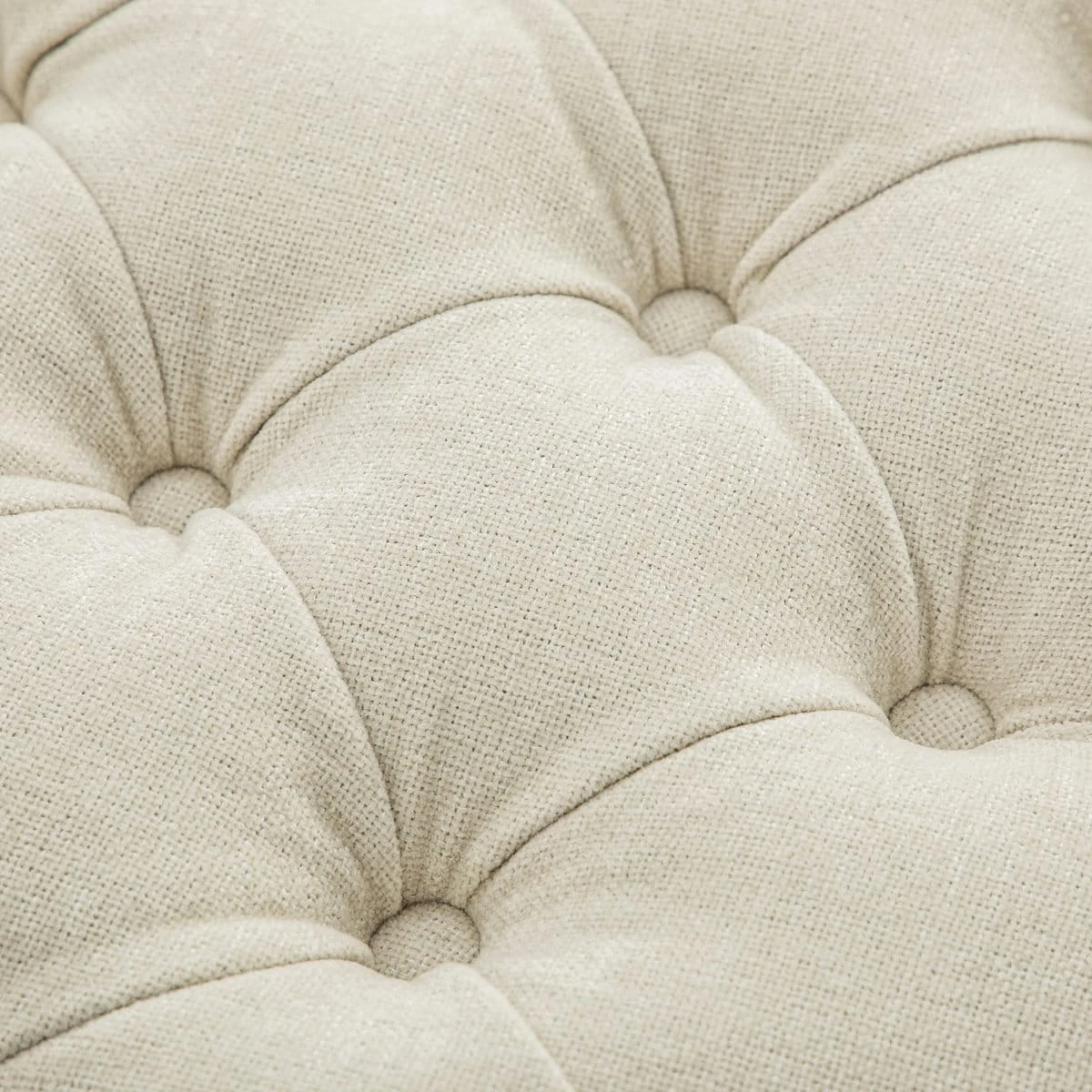 Close-up of the beige button-tufted upholstered lid with textured woven fabric