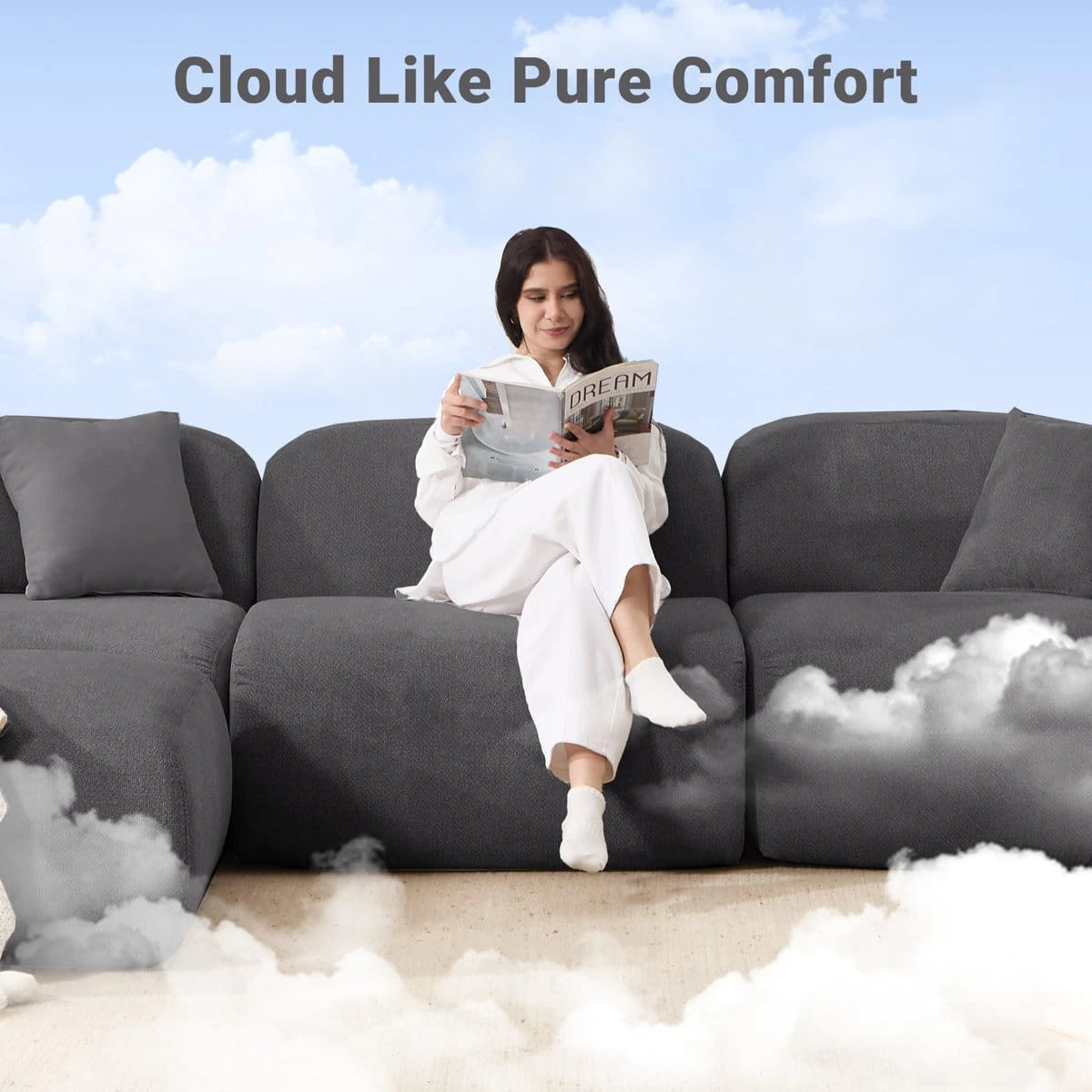 Woman reading while seated on the center module, highlighting the sofa's plush comfort and deep seat