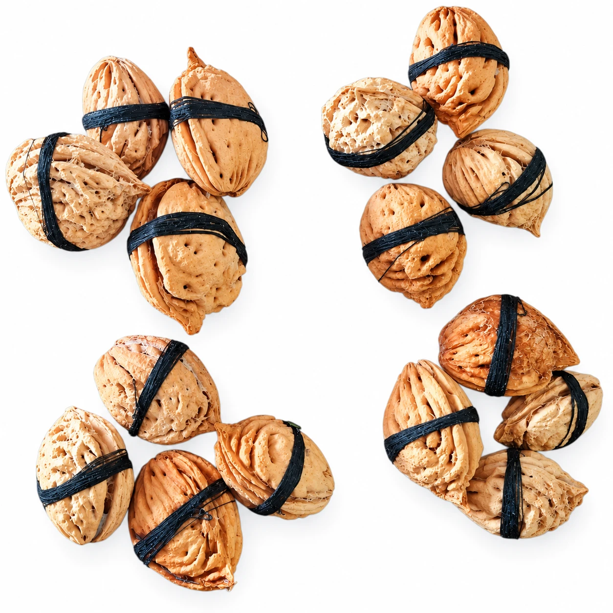 Sixteen peach kernels grouped in four clusters, each tied with black antimony thread on white background