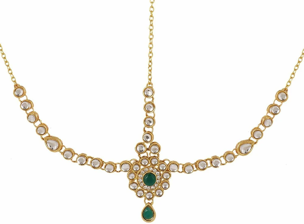 Close-up of floral medallion design with green center stone and matching green teardrop drop