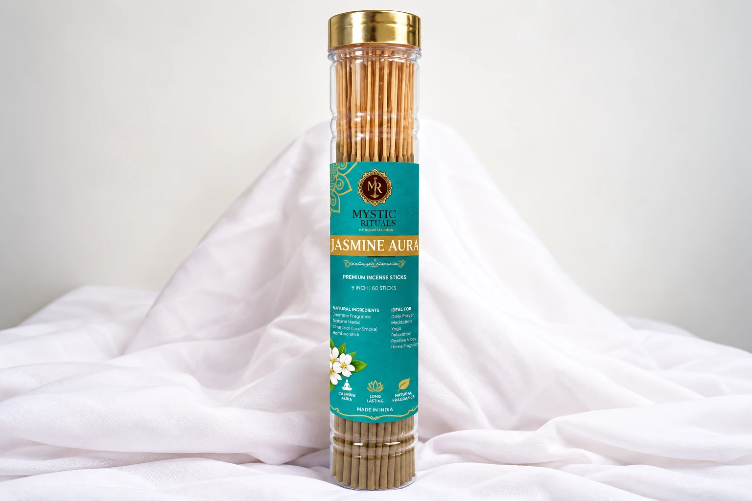 Jasmine Aura premium incense sticks tube with gold lid and teal label, displayed upright on sheer white fabric