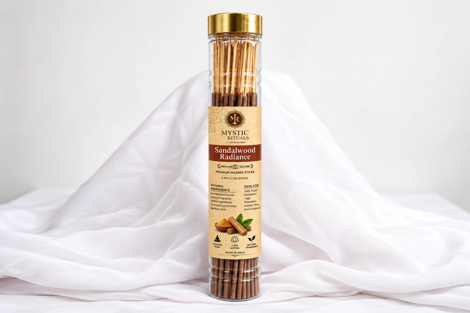 Sandalwood Radiance incense sticks in a clear tube with gold lid, front label shown on draped white fabric