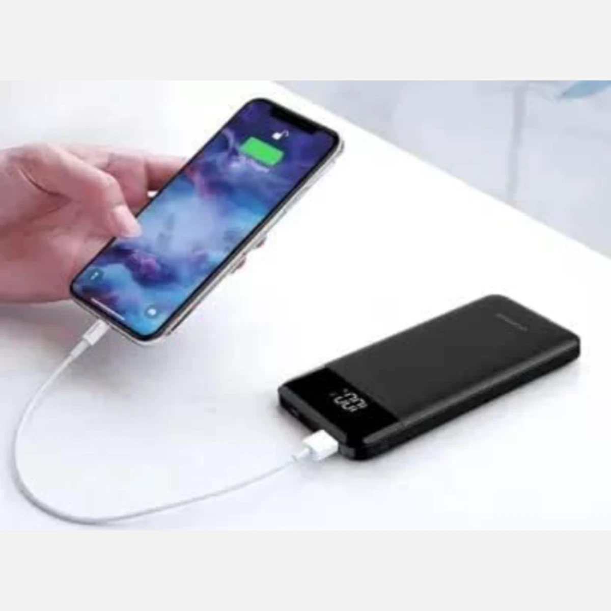 Cable connected between a smartphone and black power bank during charging