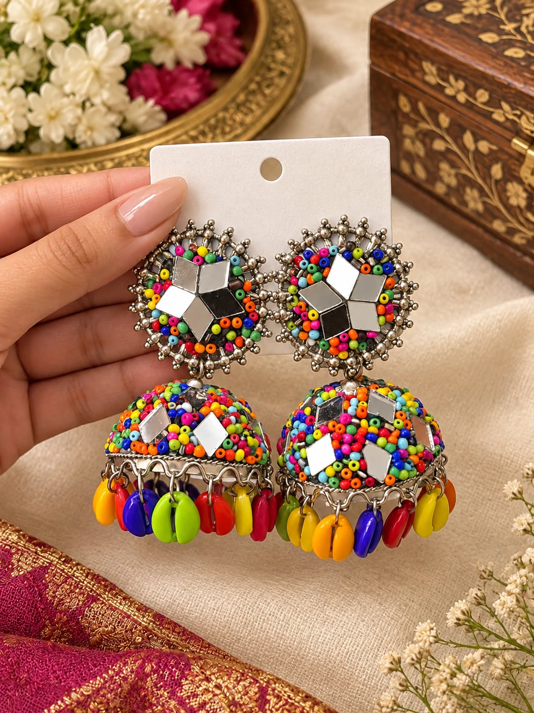 Front view of multicolor beaded jhumka earrings with mirror work and bright dangling bead charms