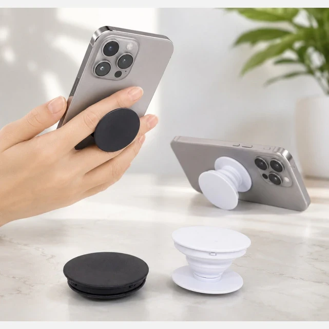Black and white collapsible phone grips shown on phones for holding and kickstand use