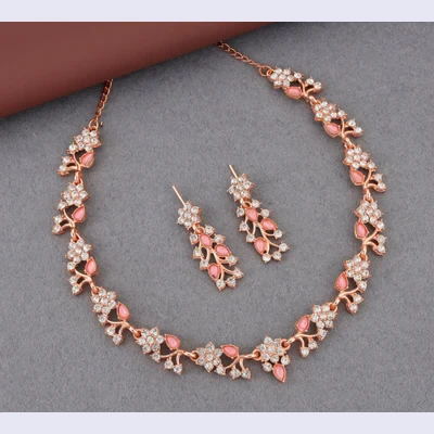 Necklace and earrings arranged on grey surface, highlighting the full floral vine pattern and delicate chain