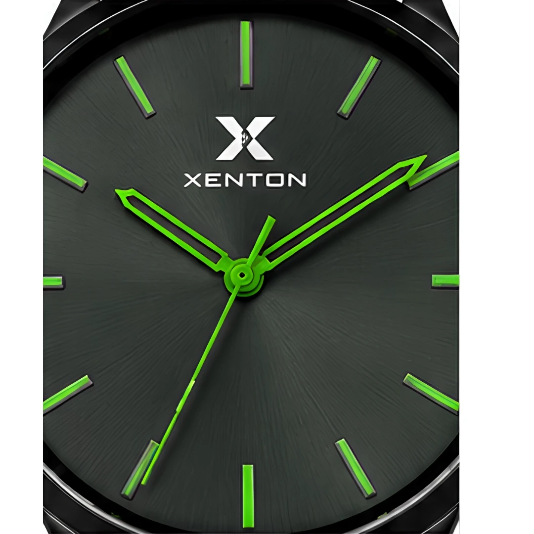 Macro close-up of the black textured dial with Xenton logo and luminous green hands and indices