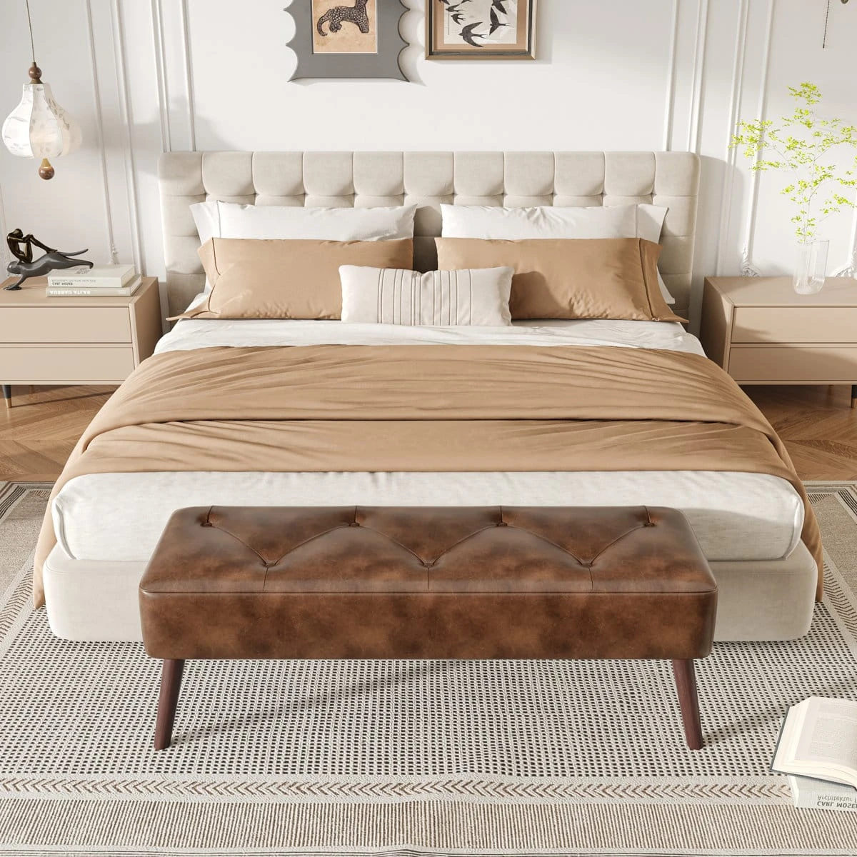 Bench placed at the foot of a bed, showing its long rectangular seat in a styled bedroom