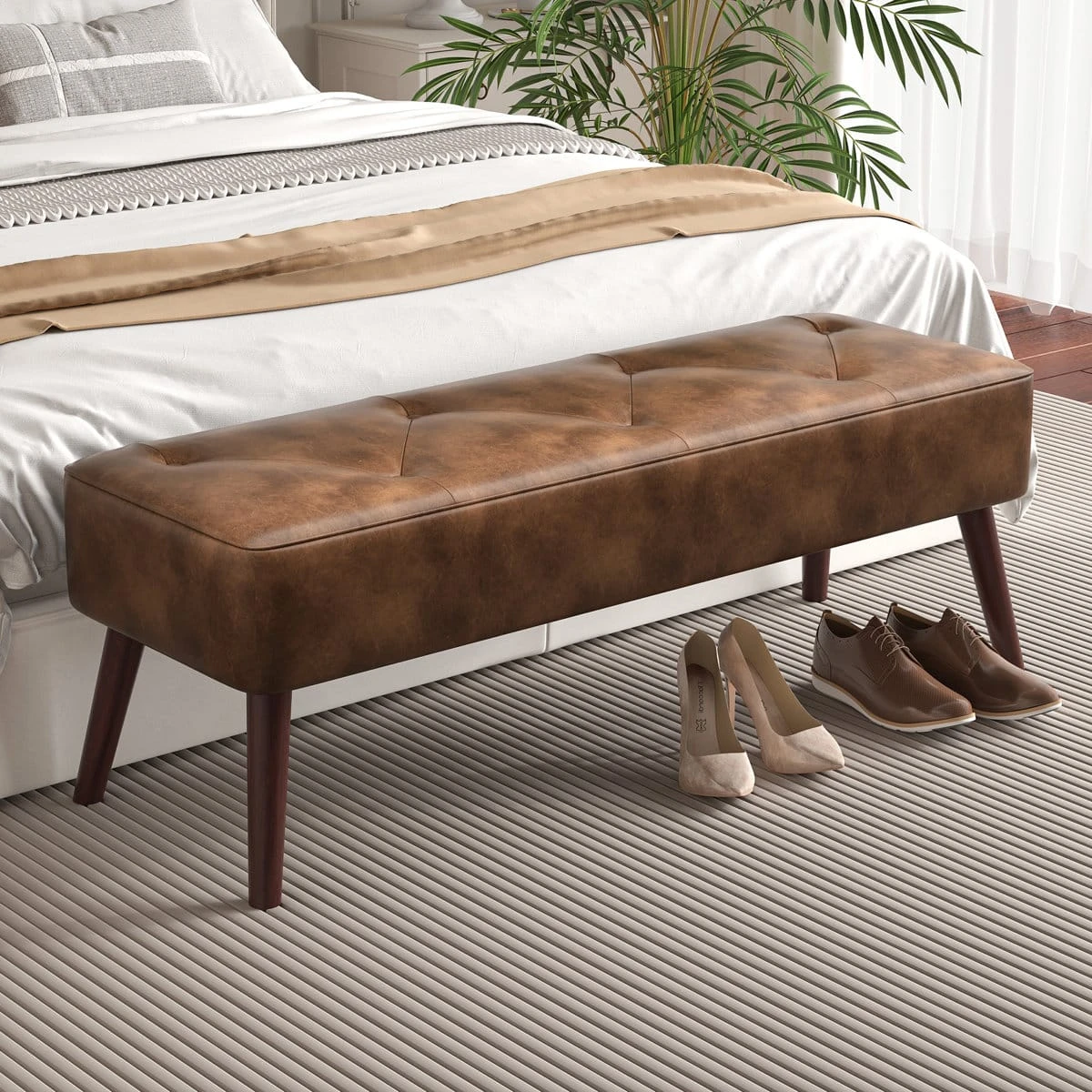 Side-angled bedroom view of the bench with shoes nearby, highlighting its slim upholstered profile