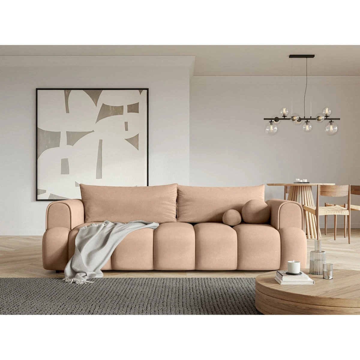Beige sofa styled in a living room with throw blanket and matching round accent cushions