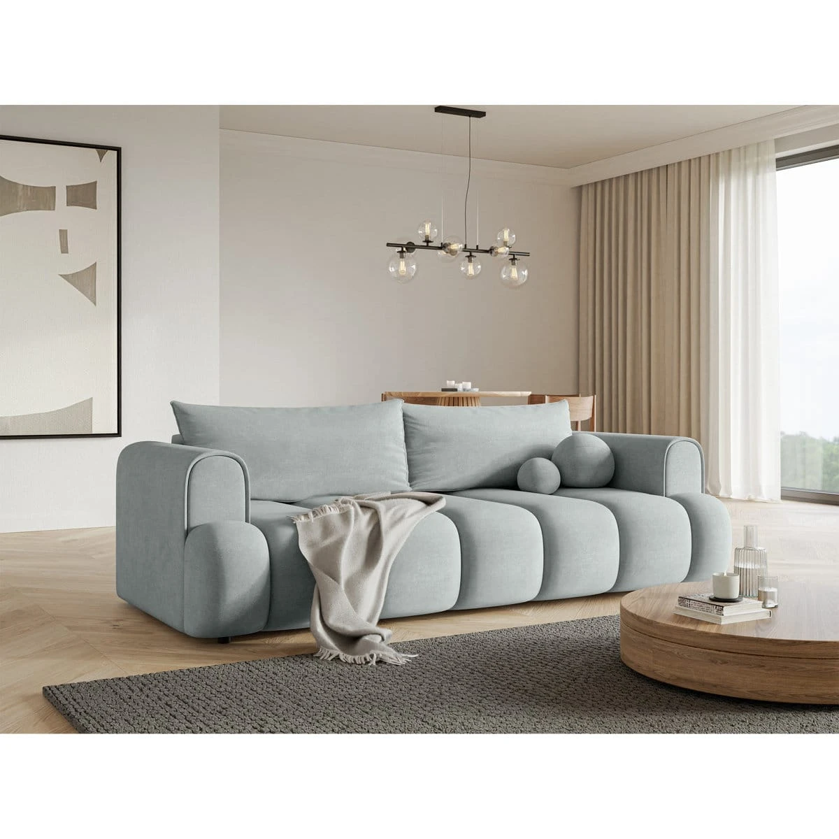 Angled room view showing the sofa beside a round wood coffee table and floor-length curtains