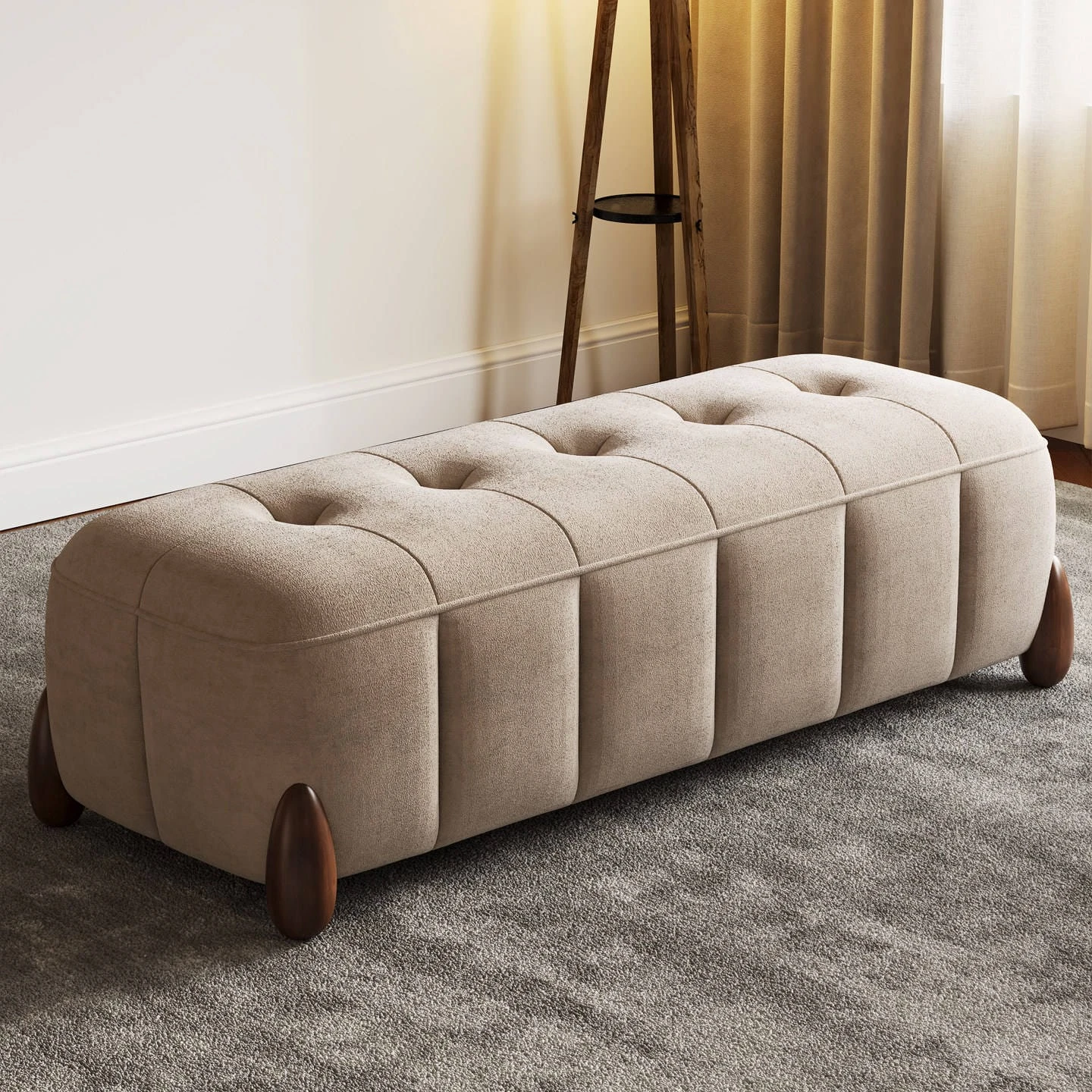 Beige upholstered bench ottoman highlighting channel sides, tufted top, and dark wood legs