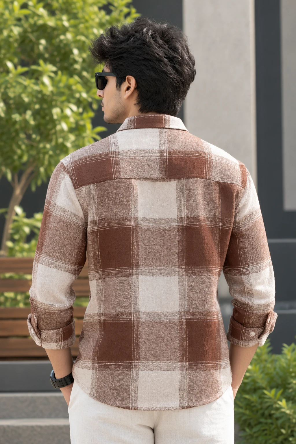 Back view of the checked shirt showing full plaid pattern and curved hem