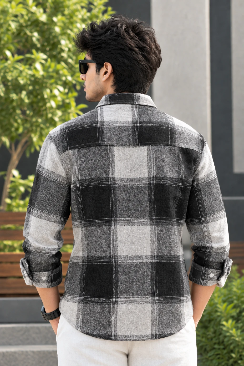 Back view of the checked shirt showing full plaid pattern and curved hem