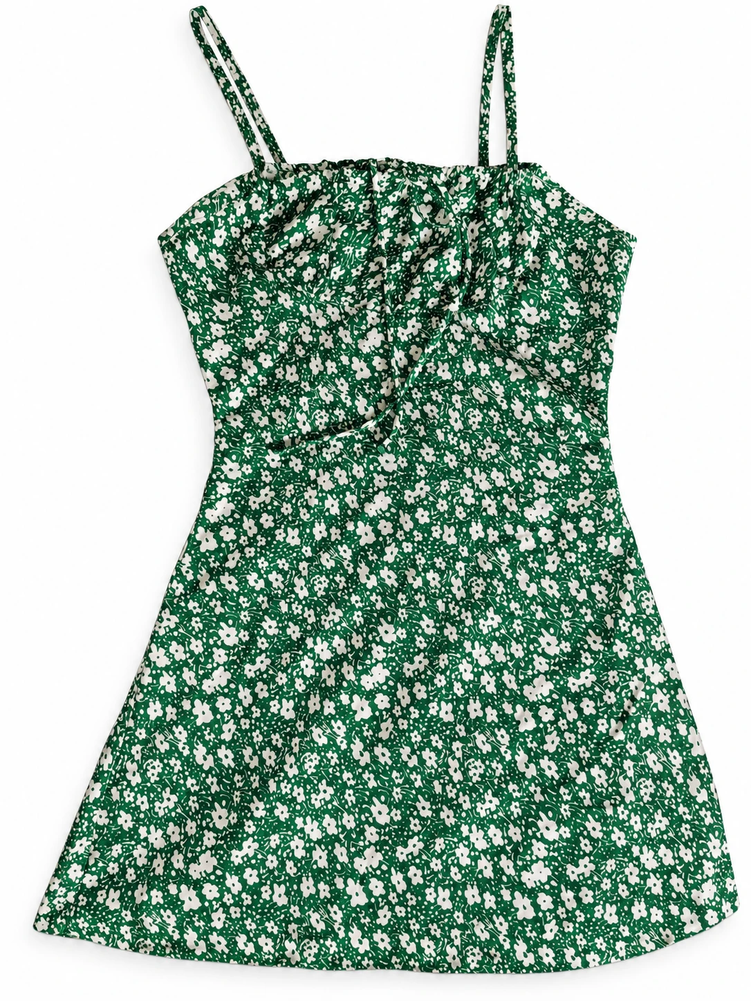 Dress laid flat on white background showing green floral print and slim shoulder straps